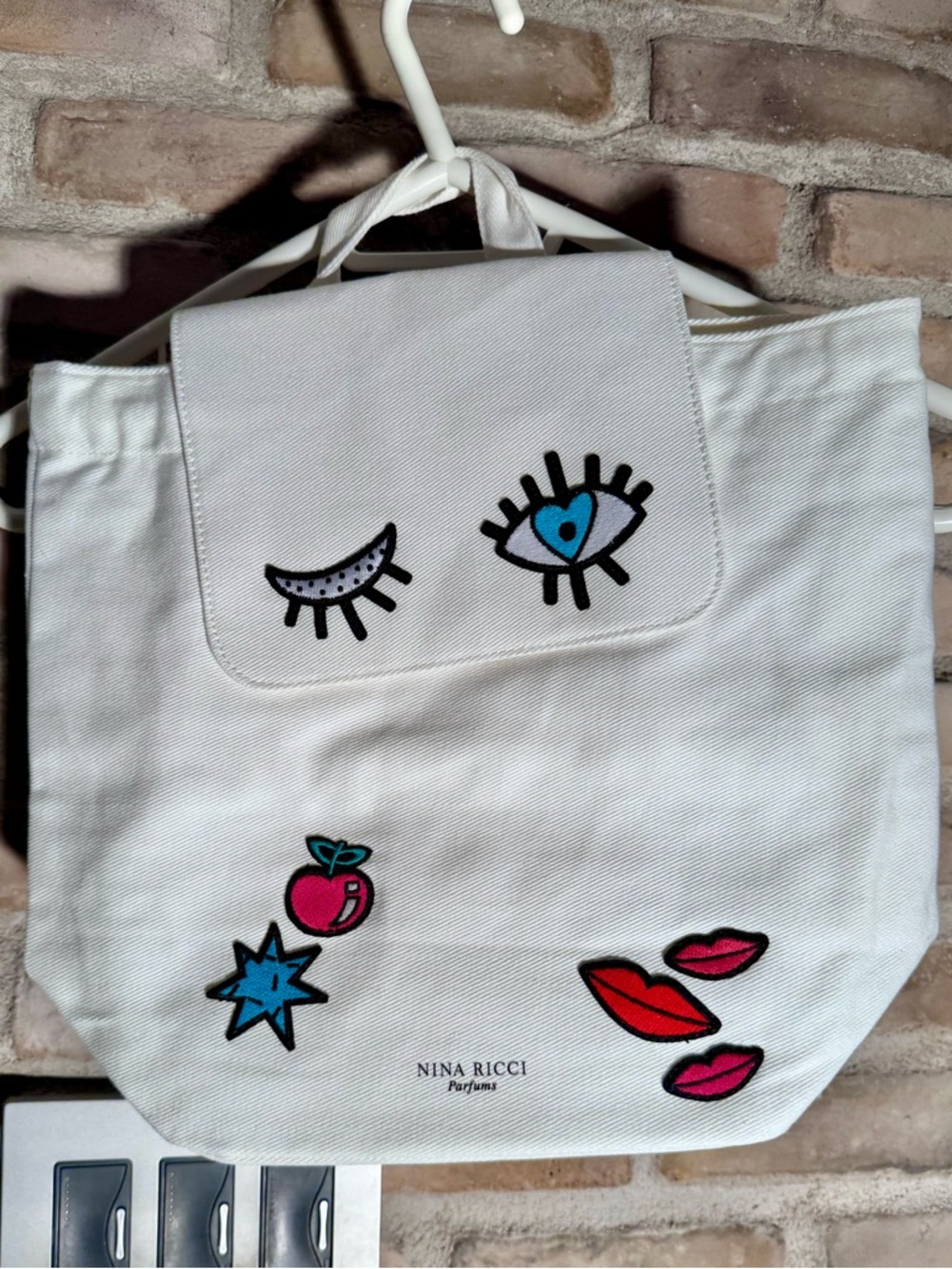 Brand new Nina Ricci White Canvas Tote with Colorful Patch Icons